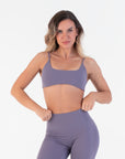 Front view of the Scoop Bralette in Acai with hands at the waistband