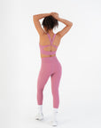Back view of the Raspberry High-Rise Leggings worn by a model