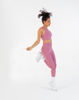 Model jumping rope in the Raspberry High-Rise Leggings