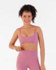 Front view of the Raspberry Scoop Bralette worn by a model