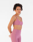 Side view of the Raspberry Scoop Bralette worn by a model