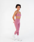 Three-quarter view of the Raspberry High-Rise Leggings worn by a model