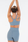 Back view of the Juniper Racerback Bra worn by a model