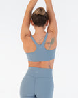 Back view of the Juniper Racerback Bra worn by a model