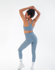 Three-quarter back view of the Juniper V-Waist Leggings worn by a model