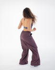 Back view of the Chia Halter Neck Sports Bra styled with loose-fit pants